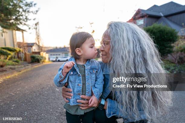 loving grandma with her granddaughter - pacific islander ethnicity stock pictures, royalty-free photos & images