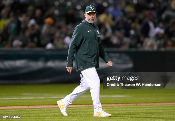 Manager Mark Kotsay of the Oakland Athletics walks to the mound to make a pitching change against the Texas Rangers in the top of the eighth inning...