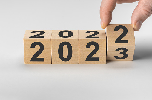 happy new year concept, Flipping of wooden cube block change from 2022 to 2023. Start new year 2023 with goal plan, goal concept, action plan, strategy, new year business vision.
