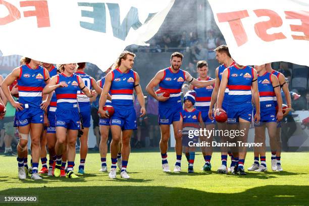 Western Bulldogs players run through the banner before the round six AFL match between the Western Bulldogs and the Adelaide Crows at Mars Stadium on...