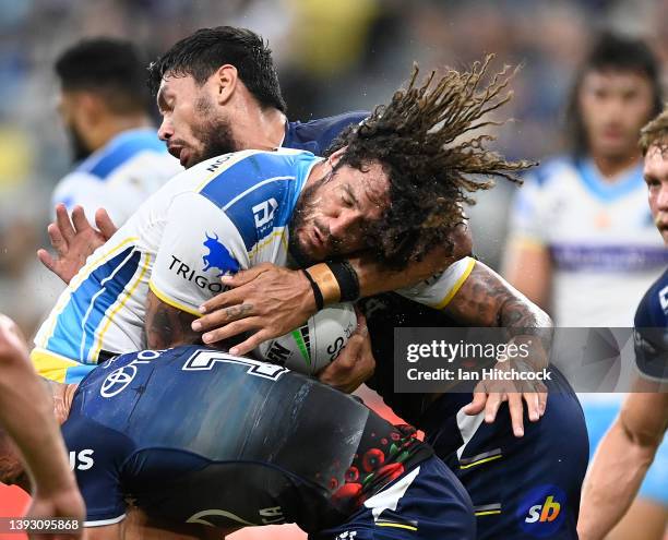 Kevin Proctor of the Titans is tackled during the round seven NRL match between the North Queensland Cowboys and the Gold Coast Titans at Qld Country...