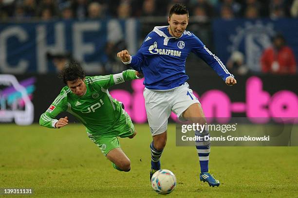 Christian Traesch of Wolfsburg and Marco Hoeger of Schalke battle for the ball during the Bundesliga match between FC Schalke 04 and VfL Wolfsburg at...