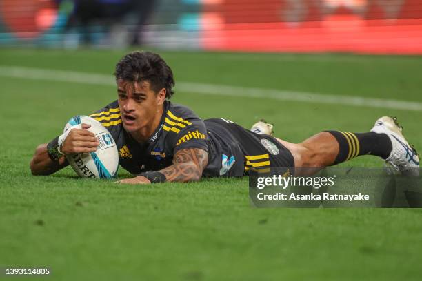 Bailyn Sullivan of the Hurricanes runs in to score a try during the round 10 Super Rugby Pacific match between the Hurricanes and the Queensland Reds...