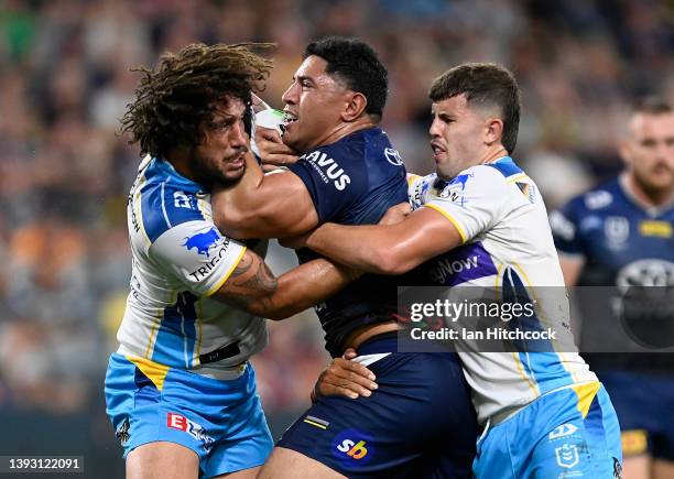 Jason Taumalolo of the Cowboys is tackled by Kevin Proctor and Toby Sexton of the Titans during the round seven NRL match between the North...