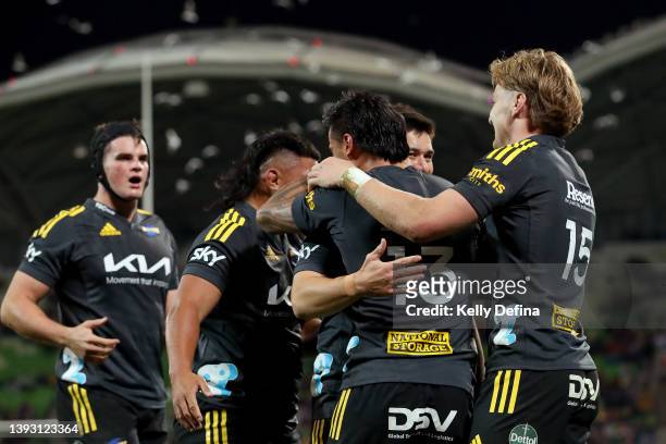 Bailyn Sullivan of the Hurricanes celebrates with team mates during the round 10 Super Rugby Pacific match between the Hurricanes and the Queensland...