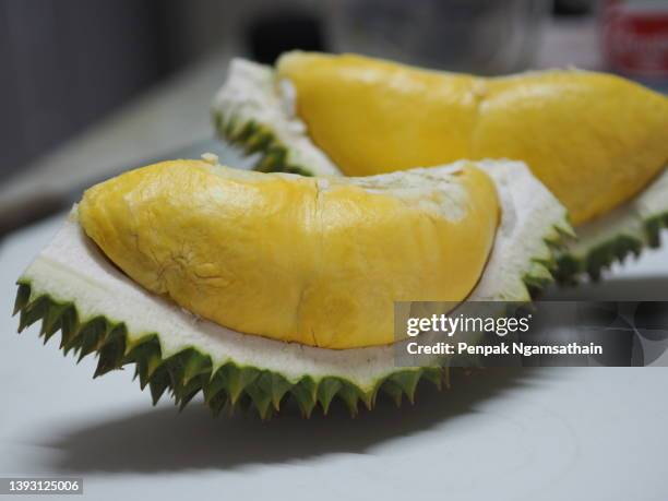 durian fruit with sharp bark flesh, in brown paper box sweet thai fruit yellow color - durian - fotografias e filmes do acervo