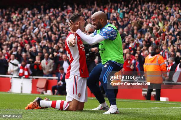 Granit Xhaka of Arsenal celebrates after scoring their side's third goal with Alexandre Lacazette during the Premier League match between Arsenal and...