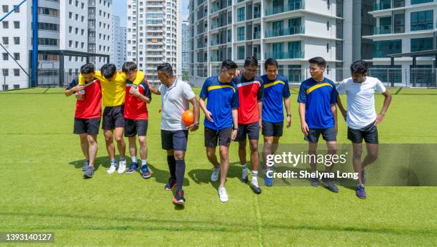 soccer team supporting injured player on soccer  field - indian football stock pictures, royalty-free photos & images