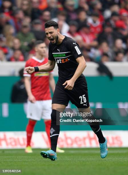 Ramy Bensebaini of Borussia Mönchengladbach celebrates after scoring their side's first goal from a penalty during the Bundesliga match between...