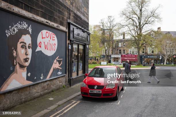 People walk past a mural painted in a wall in the Montpellier Quarter of Harrogate on April 23, 2022 in Harrogate, England. A recent report from the...