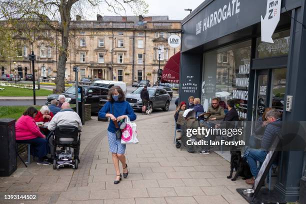 Visitors sit outside a cafe in the Montpellier Quarter of Harrogate on April 23, 2022 in Harrogate, England. A recent report from the UK Office of...