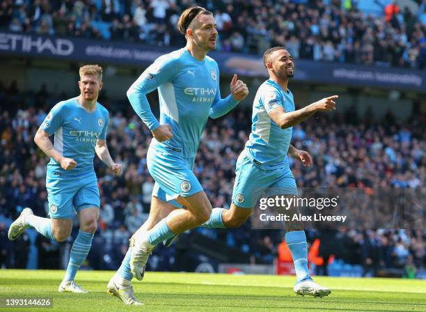 Gabriel Jesus celebrates with teammates Kevin De Bruyne and Jack Grealish of Manchester City after scoring their team's first goal during the Premier...