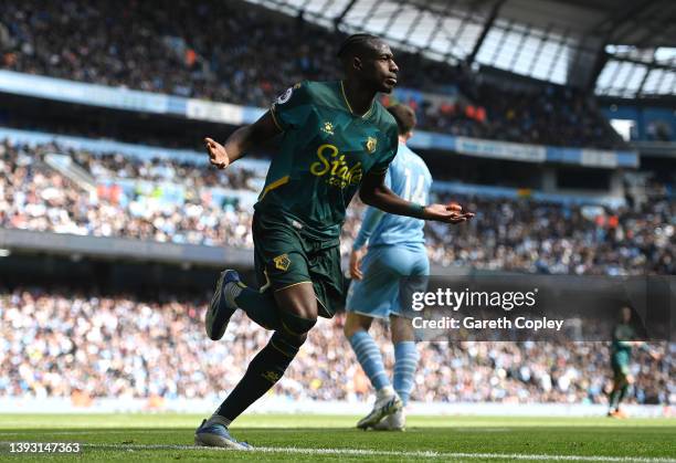 Hassane Kamara of Watford FC celebrates after scoring their team's first goal during the Premier League match between Manchester City and Watford at...