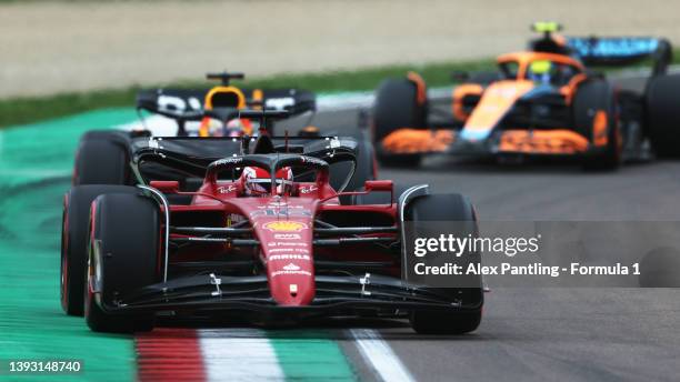 Charles Leclerc of Monaco driving the Ferrari F1-75 leads Max Verstappen of the Netherlands driving the Oracle Red Bull Racing RB18 and Lando Norris...