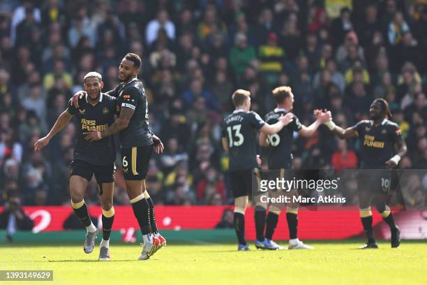 Joelinton of Newcastle United celebrates after scoring their side's first goal with Jamaal Lascelles during the Premier League match between Norwich...