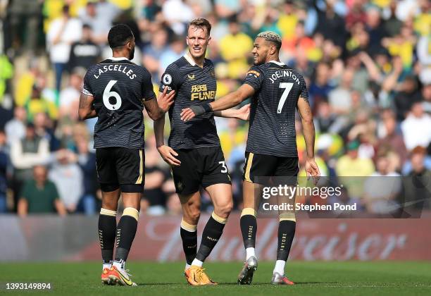 Joelinton of Newcastle United celebrates after scoring their side's first goal with Jamaal Lascelles and Dan Burn during the Premier League match...