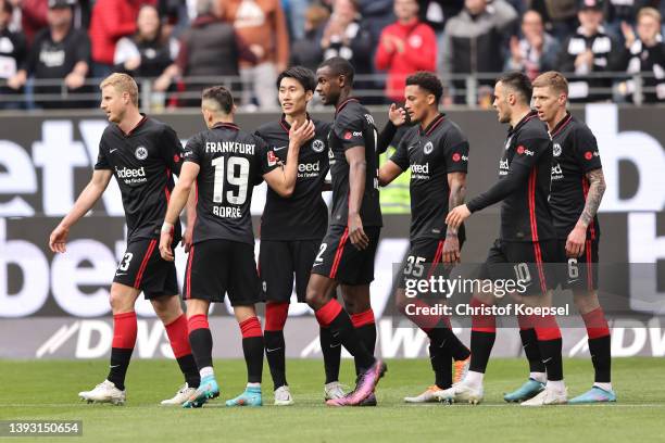 Daichi Kamada of Eintracht Frankfurt celebrates with teammates after scoring their team's second goal during the Bundesliga match between Eintracht...