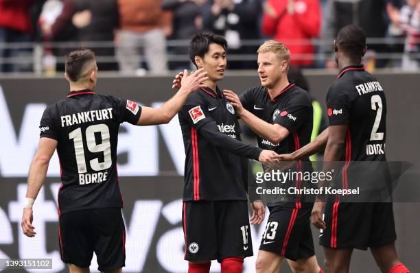 Daichi Kamada of Eintracht Frankfurt celebrates with teammates Rafael Santos Borre, Martin Hinteregger and Evan Ndicka after scoring their team's...