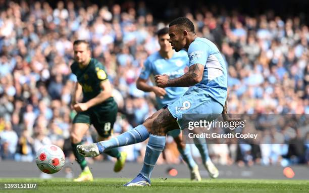 Gabriel Jesus of Manchester City scores their side's third goal from a penalty during the Premier League match between Manchester City and Watford at...
