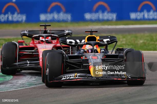Max Verstappen of the Netherlands driving the Oracle Red Bull Racing RB18 overtakes Charles Leclerc of Monaco driving the Ferrari F1-75 for the lead...