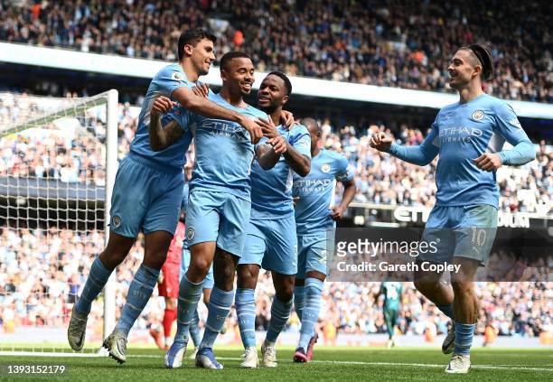 Gabriel Jesus celebrates with teammates Rodrigo, Jack Grealish and Raheem Sterling of Manchester City after scoring their side's fourth goal from a...