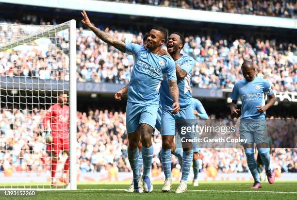 Gabriel Jesus celebrates with teammates Rodrigo and Raheem Sterling of Manchester City after scoring their side's fourth goal from a penalty during...
