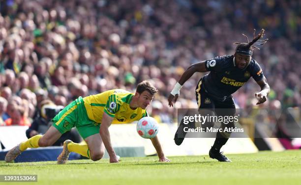 Allan Saint-Maximin of Newcastle United is challenged by Christoph Zimmermann of Norwich City during the Premier League match between Norwich City...