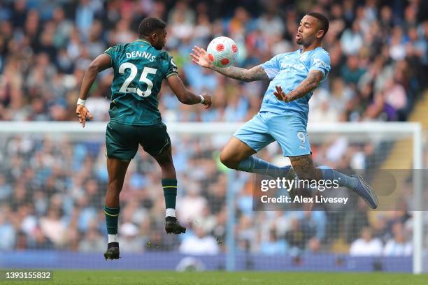 Gabriel Jesus of Manchester City battles for possession with Emmanuel Dennis of Watford FC during the Premier League match between Manchester City...