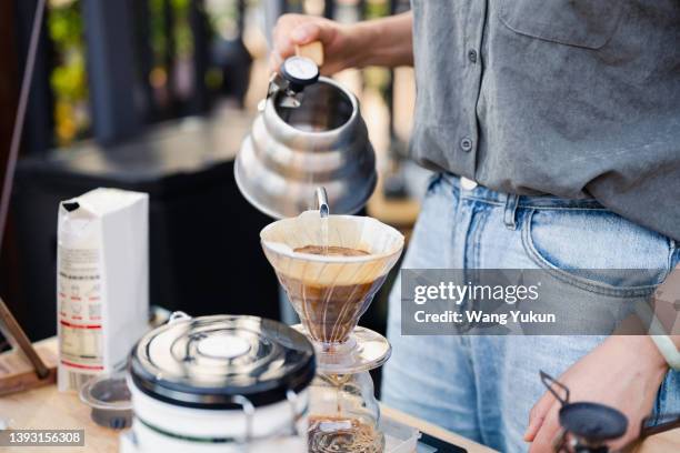 close up of young female barista making coffee - coffee drip ストックフォトと画像