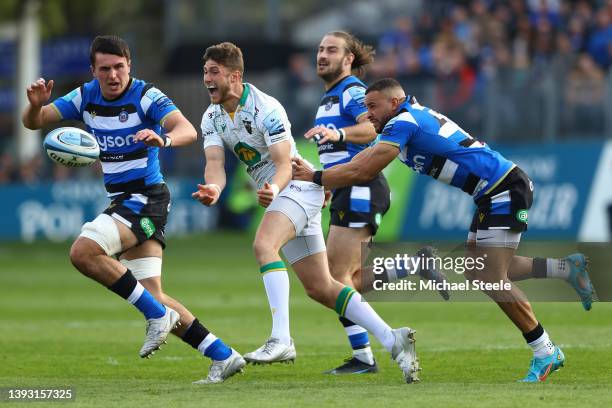 James Grayson of Northampton passes under pressure from Jonathan Joseph and Ewan Richards of Bath during the Gallagher Premiership Rugby match...