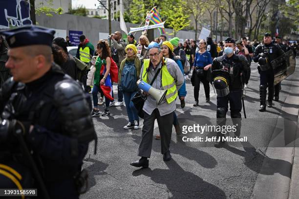 Gilet Jaune demonstrators protest as they make their way from Place d Italia to Place de Nation on April 23, 2022 in Paris, France. Emmanuel Macron...