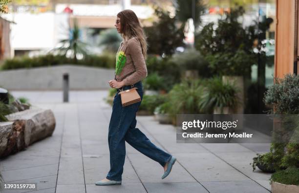 Veronika Heilbrunner seen wearing a brown Miu Miu sunglasses, a silver pearl necklace, a black top from Zara, a fluffy beige cardigan with...