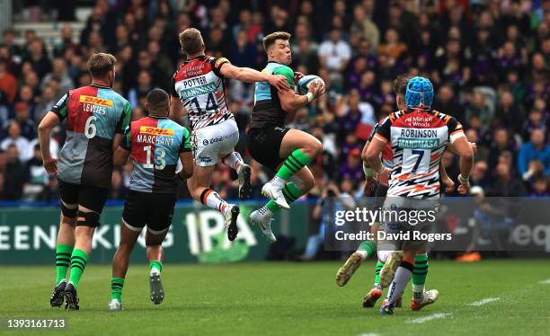 Huw Jones of Harlequins catches the ball despite being challenged by Harry Potter during the Gallagher Premiership Rugby match between Harlequins and...