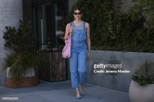 Veronika Heilbrunner seen wearing a black sunglasses, pearl earrings, a grey top from Zara, a blue denim overall from Calvin Klein, a light pink...