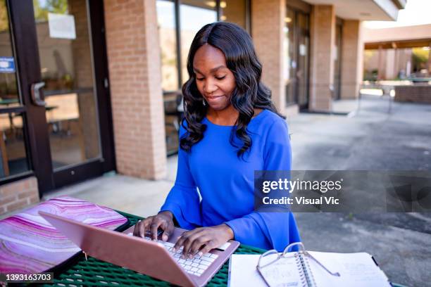 teacher using device outside - administrative professional day stock pictures, royalty-free photos & images