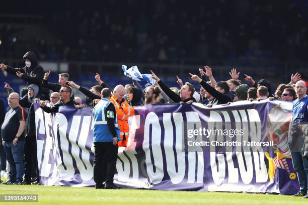 Oldham Athletic fans protest on the pitch while holding a banner which reads 'Get Out Of Our Club' leading to the match to be abandoned during the...