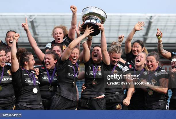 Players of Exeter Chiefs Women celebrate as co-captains Kate Zackary and Poppy Leitch lift the Allianz Cup after victory in the Allianz Cup Final...
