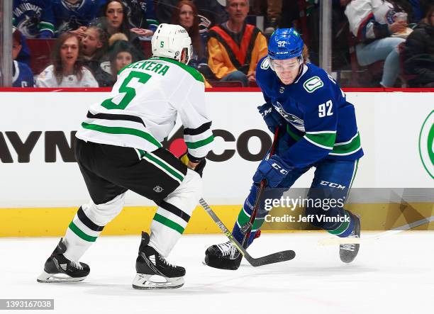 Andrej Sekera of the Dallas Stars looks on as Vasily Podkolzin of the Vancouver Canucks skates up ice during their NHL game at Rogers Arena April 18,...