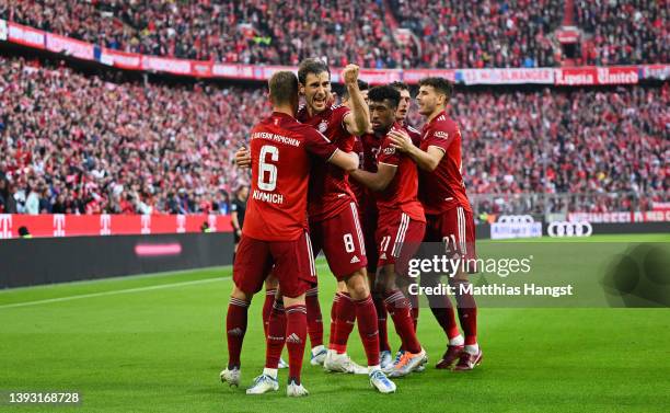 Robert Lewandowski of FC Bayern Muenchen celebrates with teammates after scoring their team's second goal during the Bundesliga match between FC...