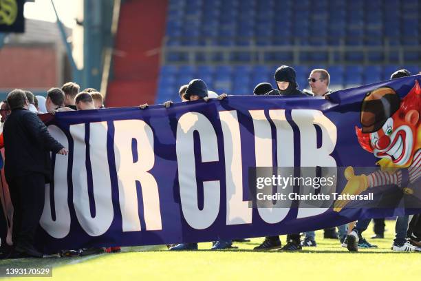 Oldham Athletic fans pitch invade while holding a banner which reads 'Get Out Of Our Club' leading to the match to be abandoned during the Sky Bet...