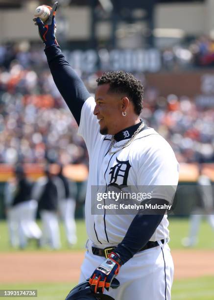 Miguel Cabrera of the Detroit Tigers holds the ball and acknowledges the crowd after he hit a single, the 3000th hit of his career, during the first...