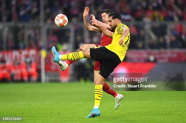 Robert Lewandowski of FC Bayern Muenchen is challenged by Emre Can of Borussia Dovrtmund during the Bundesliga match between FC Bayern Muenchen and...