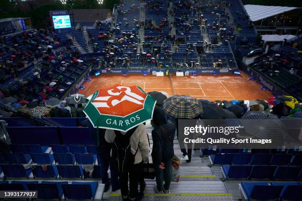 Umbrellas are raised as play is suspended during day six of the Barcelona Open Banc Sabadell at Real Club De Tenis Barcelona on April 23, 2022 in...