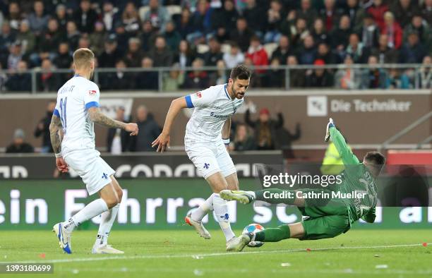 Luca Pfeiffer of SV Darmstadt 98 scores his sides first goal against Goalkeeper Nikola Vasilj of FC St. Pauli during the Second Bundesliga match...