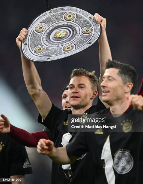Joshua Kimmich of FC Bayern Muenchen celebrates after their sides victory which wins FC Bayern Muenchen the Bundesliga title during the Bundesliga...