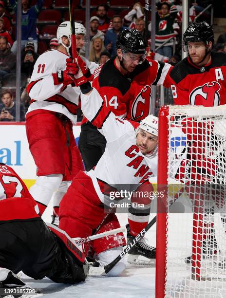 Nino Niederreiter and Jordan Staal of the Carolina Hurricanes celebrate a goal during the third period as Nathan Bastian and Damon Severson of the...