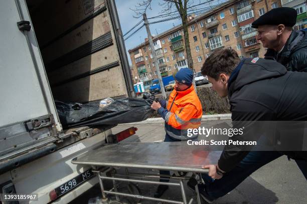 Corpse in a bodybag is pulled from a lorry, as a Ukrainian morgue overflows with victims who died during the Russian military presence in the Kyiv...