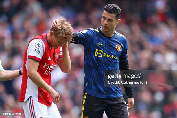 Cristiano Ronaldo of Manchester United checks on Martin Odegaard of Arsenal during the Premier League match between Arsenal and Manchester United at...