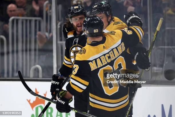 David Pastrnak of the Boston Bruins celebrates with Brad Marchand after scoring against the New York Rangers during the first period at TD Garden on...