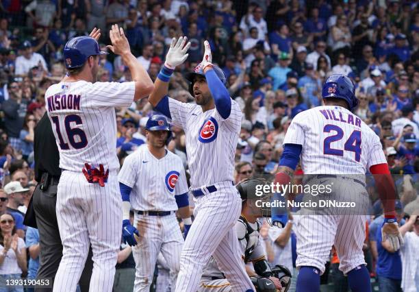 Alfonso Rivas of the Chicago Cubs is congratulated by Patrick Wisdom of the Chicago Cubs following his three run home run during the second inning of...